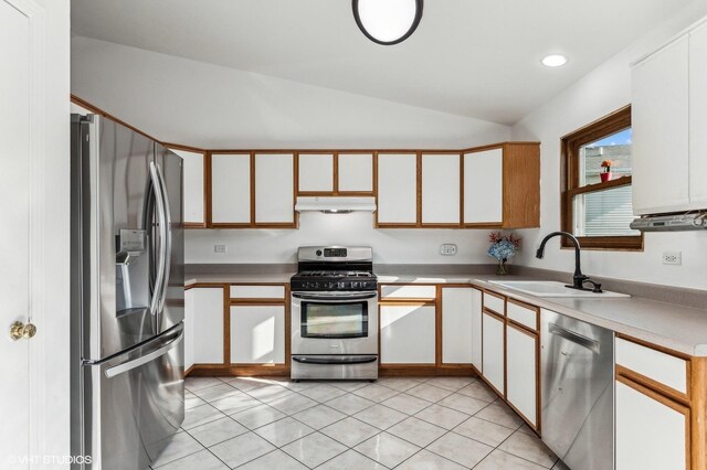 kitchen featuring white cabinets, lofted ceiling, and stainless steel appliances