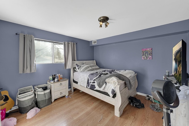 bedroom with light hardwood / wood-style flooring