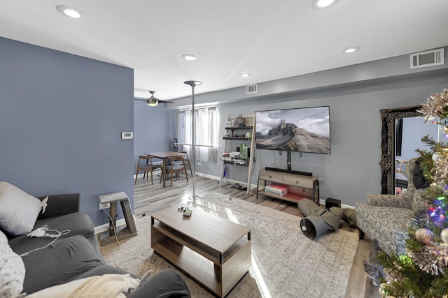 living room with ceiling fan and light wood-type flooring