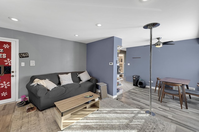 living room with ceiling fan and light wood-type flooring