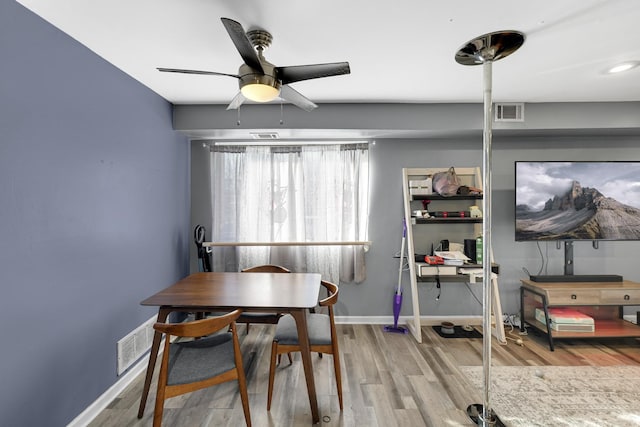 dining area with ceiling fan and light hardwood / wood-style flooring