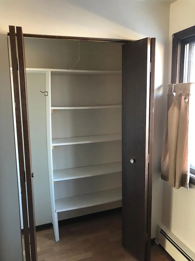 closet with a baseboard heating unit