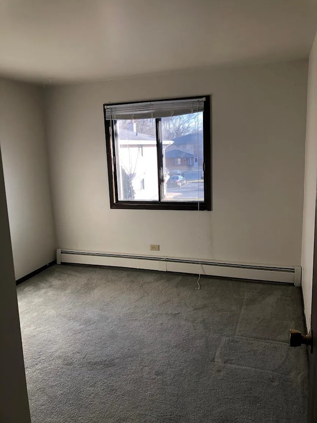 unfurnished room featuring carpet and baseboard heating