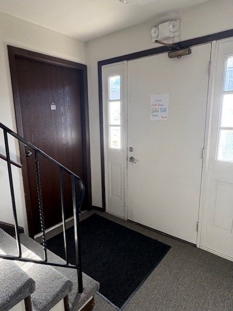 view of carpeted foyer entrance