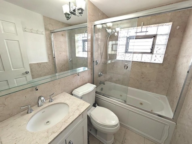 full bathroom with tasteful backsplash, vanity, bath / shower combo with glass door, and toilet