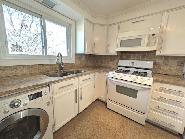 kitchen with ornamental molding, white appliances, sink, white cabinets, and washer / dryer