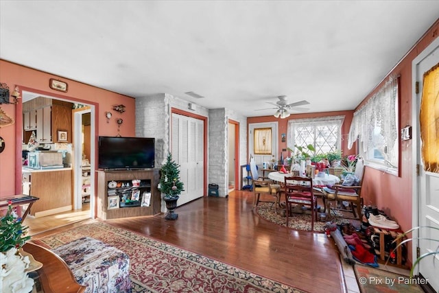 living room with hardwood / wood-style flooring and ceiling fan