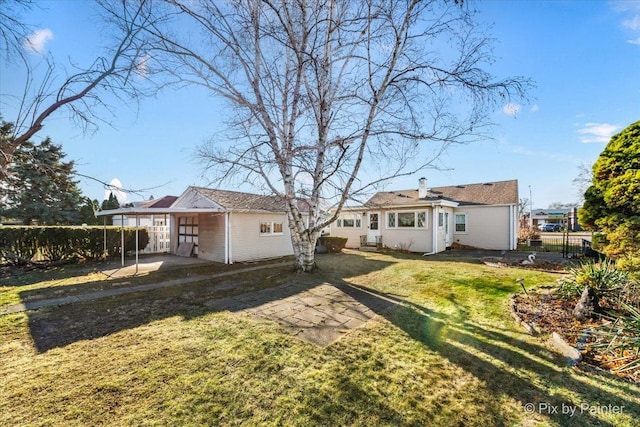 rear view of house featuring a patio area and a yard