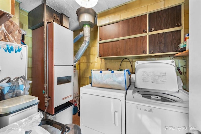 laundry area featuring cabinets and washing machine and clothes dryer