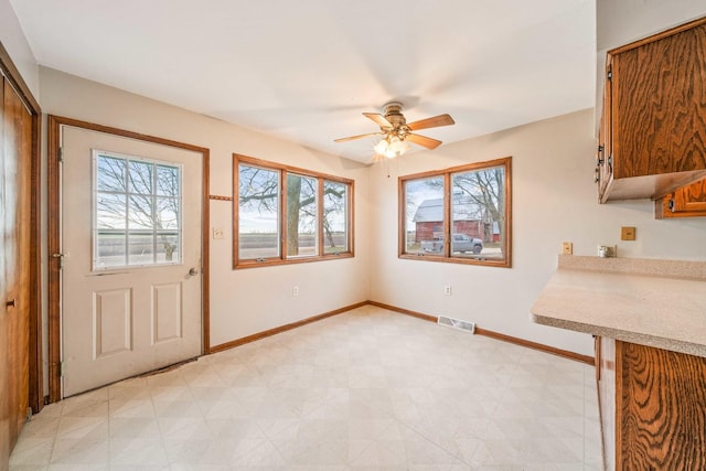 unfurnished dining area featuring ceiling fan