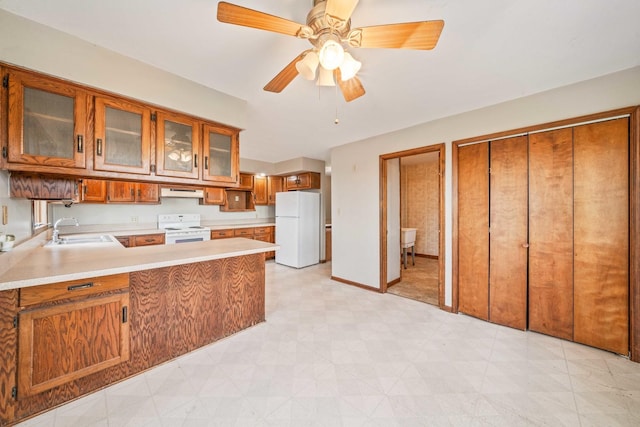 kitchen with kitchen peninsula, white appliances, ceiling fan, exhaust hood, and sink