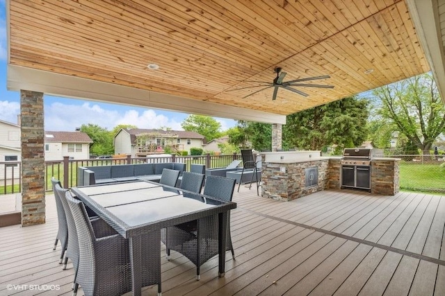 wooden terrace with area for grilling, an outdoor hangout area, and a ceiling fan