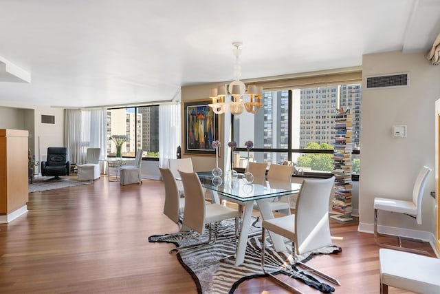 dining room featuring dark hardwood / wood-style flooring and a notable chandelier