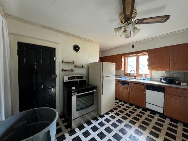 kitchen with decorative backsplash, white appliances, ceiling fan, and sink