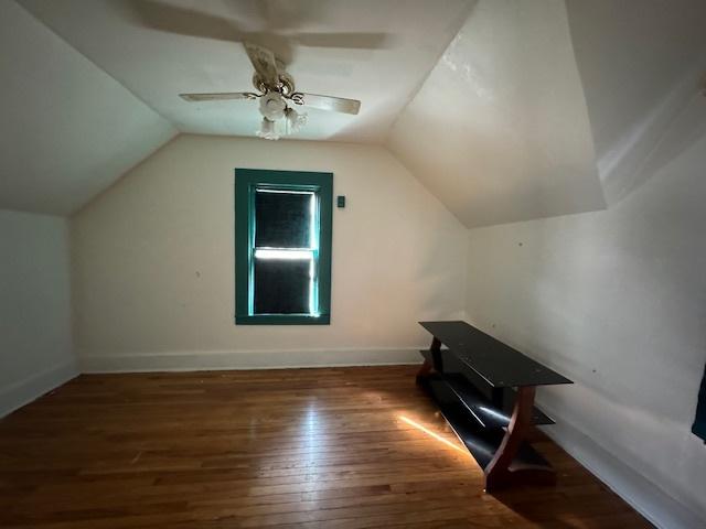 bonus room featuring ceiling fan, dark wood-type flooring, and vaulted ceiling