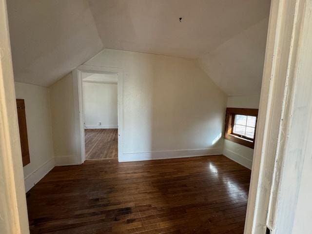 bonus room featuring lofted ceiling and dark wood-type flooring