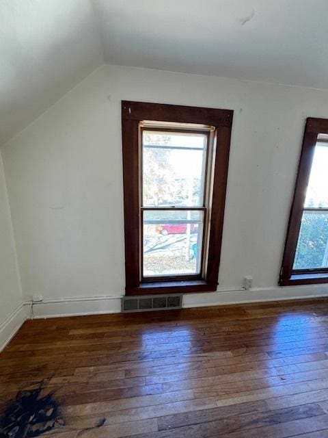 bonus room featuring dark hardwood / wood-style flooring and lofted ceiling