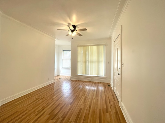 unfurnished room with crown molding, hardwood / wood-style floors, and ceiling fan