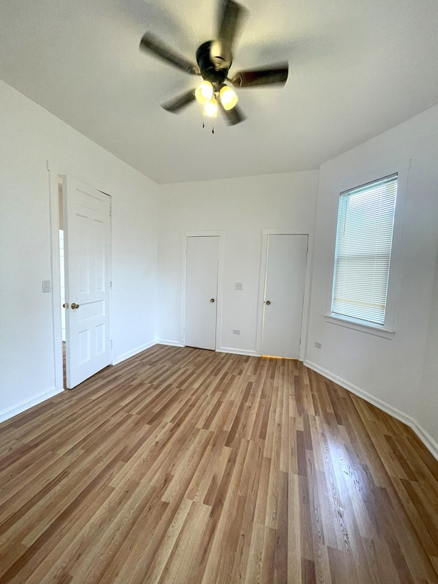 unfurnished bedroom featuring ceiling fan and light wood-type flooring