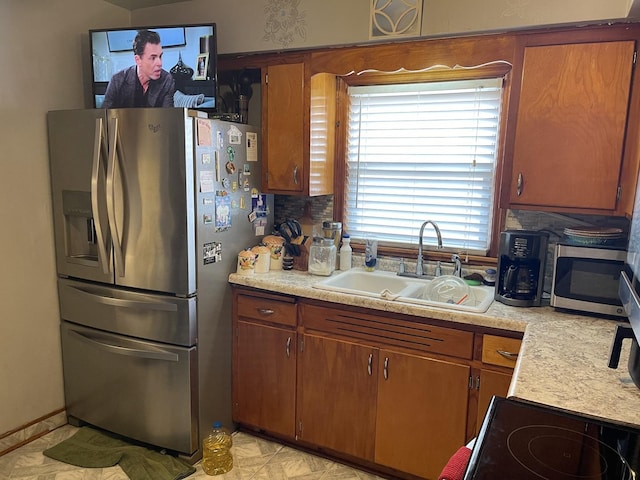 kitchen with decorative backsplash, stainless steel appliances, and sink