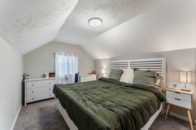 carpeted bedroom with a textured ceiling and vaulted ceiling