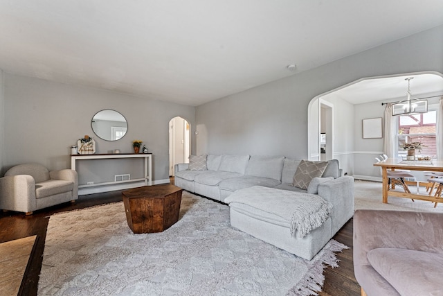 living room featuring a chandelier and hardwood / wood-style flooring