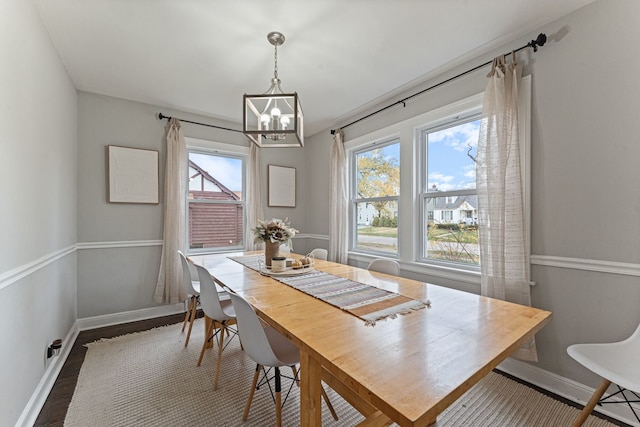 dining area featuring a notable chandelier and dark hardwood / wood-style floors