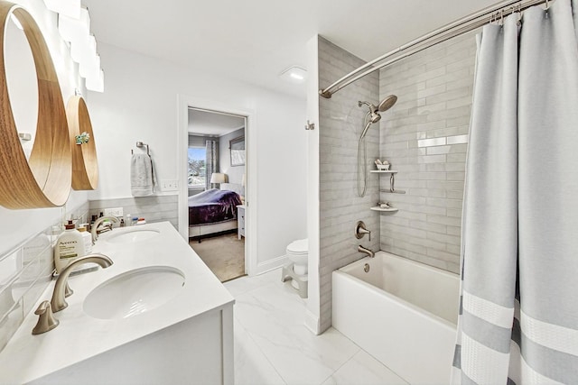 full bathroom featuring shower / bath combo with shower curtain, toilet, and vanity