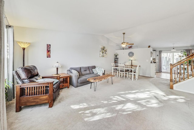 living room with ceiling fan, light colored carpet, and lofted ceiling