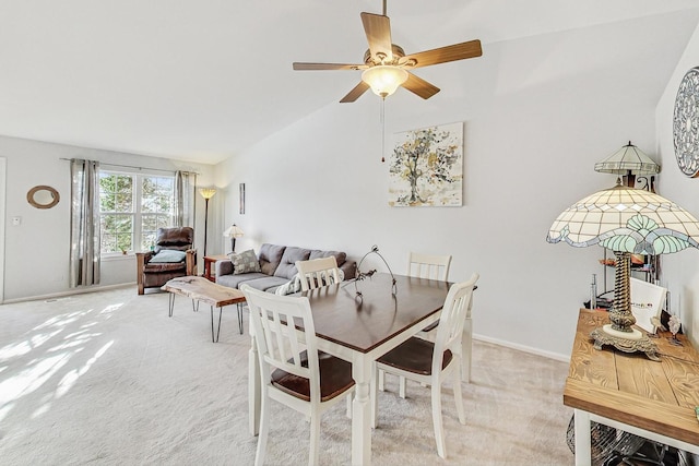 dining room featuring ceiling fan, light colored carpet, and lofted ceiling