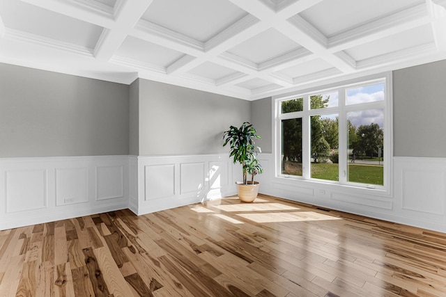 unfurnished room with beam ceiling, light wood-type flooring, and coffered ceiling