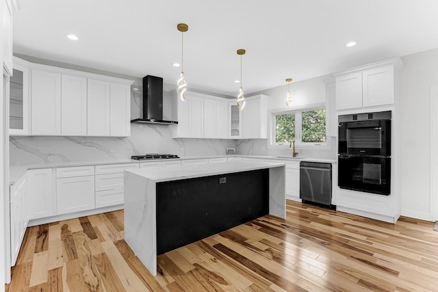 kitchen with white cabinets, wall chimney exhaust hood, and light wood-type flooring