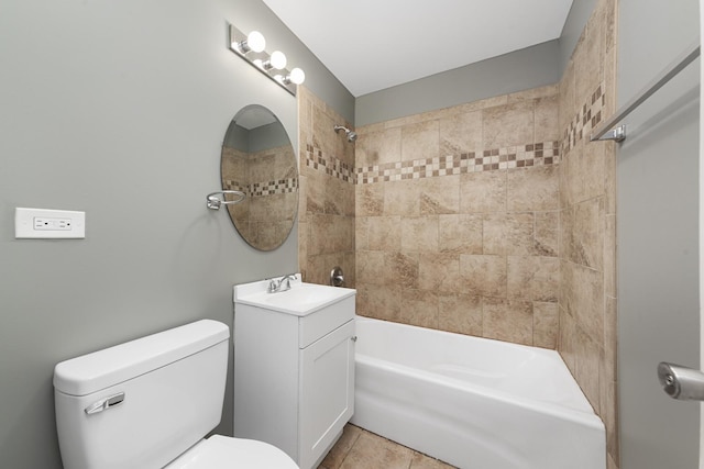 full bathroom featuring toilet, tile patterned flooring, vanity, and tiled shower / bath