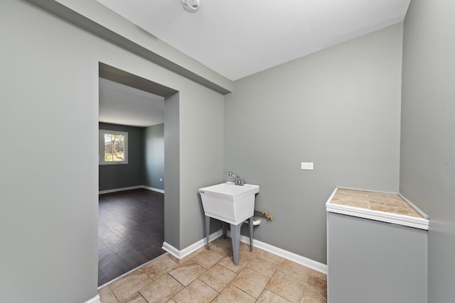 laundry area with light hardwood / wood-style floors