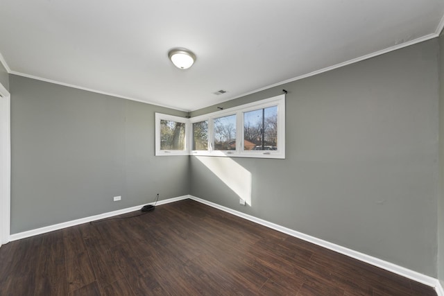 spare room with crown molding and dark wood-type flooring