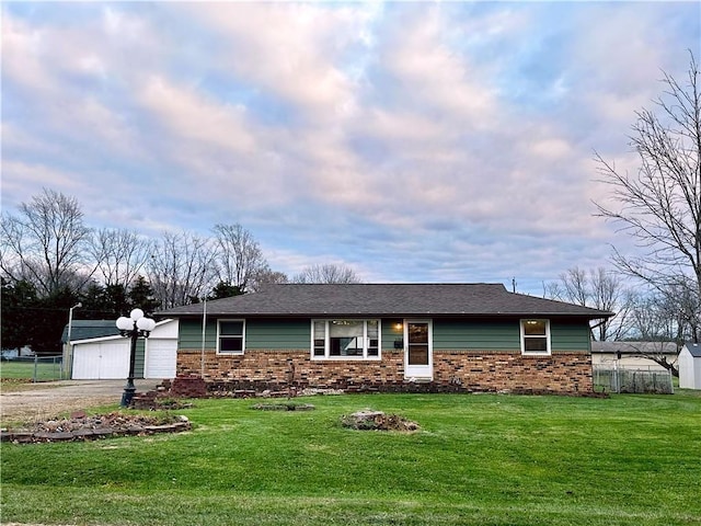 ranch-style house with a garage and a front lawn