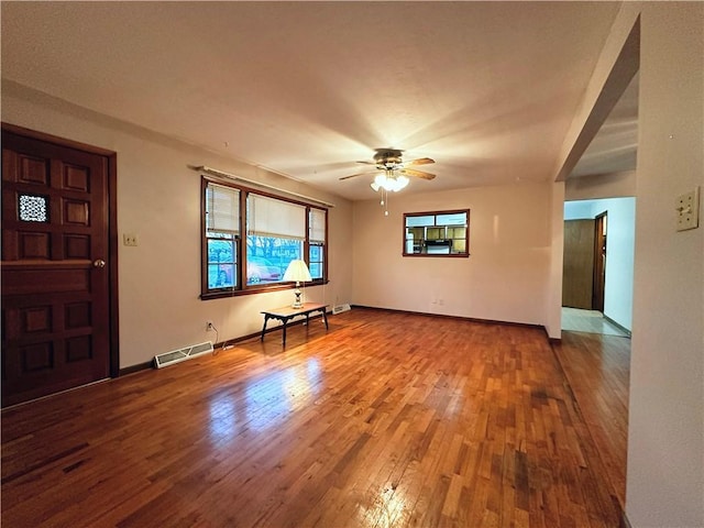 unfurnished living room featuring hardwood / wood-style flooring and ceiling fan