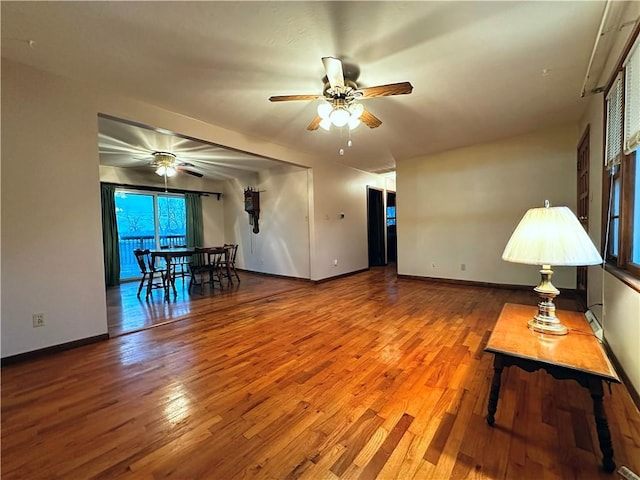 unfurnished living room with hardwood / wood-style floors and ceiling fan