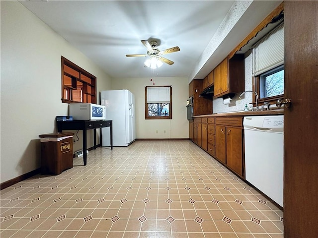 kitchen with ceiling fan, white appliances, and decorative backsplash