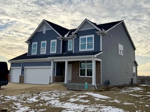 view of front of home featuring a porch and a garage