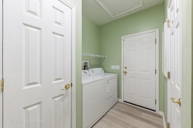 clothes washing area featuring independent washer and dryer and light wood-type flooring