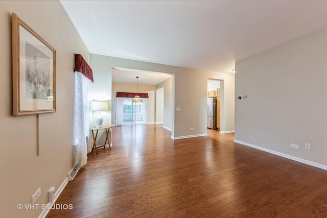 unfurnished room featuring dark hardwood / wood-style flooring