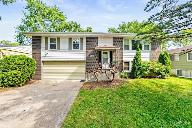 bi-level home featuring a garage and a front lawn