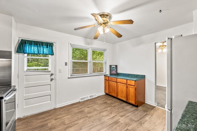 kitchen featuring ceiling fan, light hardwood / wood-style flooring, and stainless steel appliances