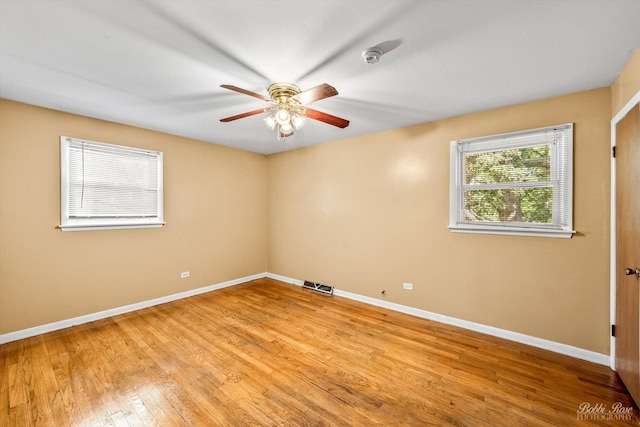 spare room with light wood-type flooring and ceiling fan