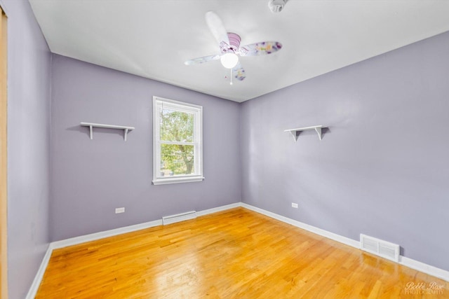 empty room featuring wood-type flooring and ceiling fan