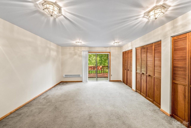 unfurnished bedroom featuring two closets, access to outside, a baseboard heating unit, and light colored carpet