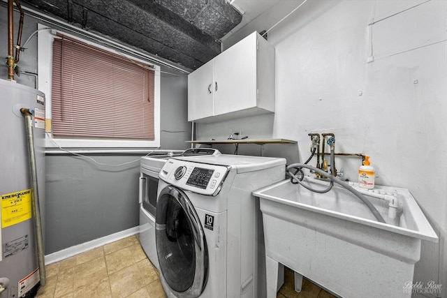 laundry area with washer and clothes dryer, cabinets, sink, and water heater