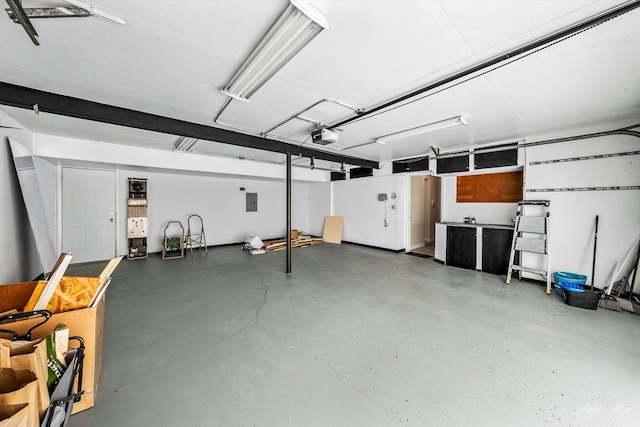 garage featuring electric panel and a garage door opener