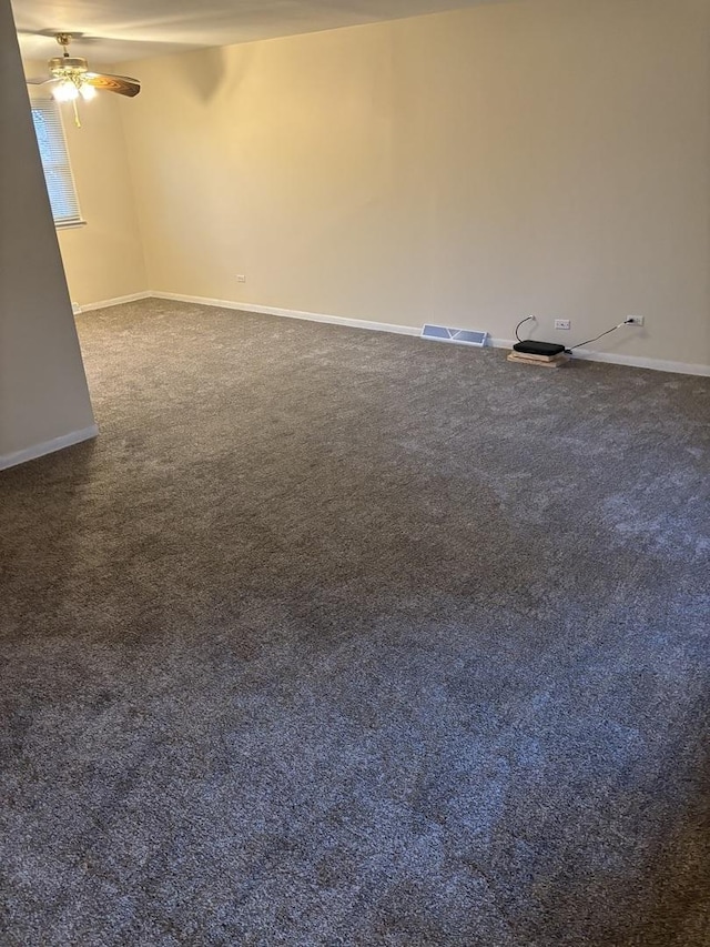 unfurnished room with dark carpet